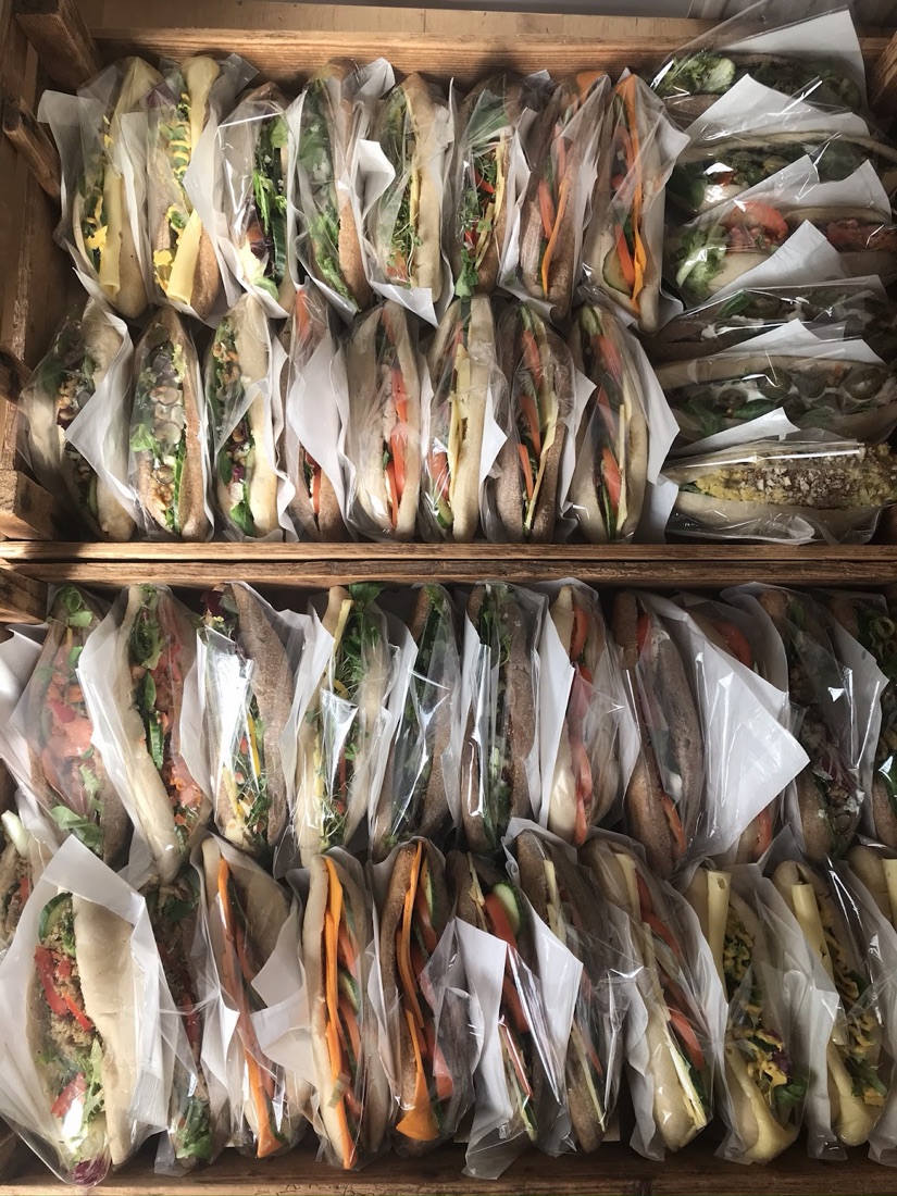 Wooden crates packed with freshly made vegetarian sourdough sandwiches and filled baguettes at Wapping Sourdough